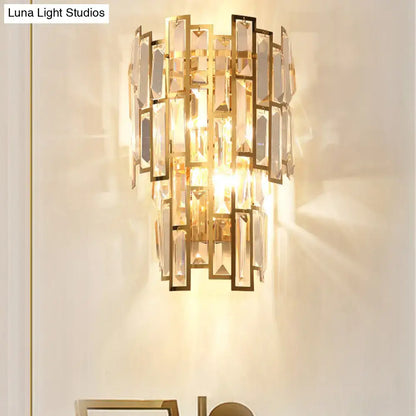 Postmodern gold sconce light fixture with cascading rectangular crystal panels in sleek metal for living room walls