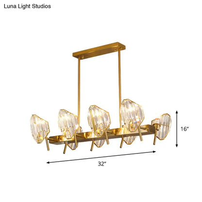 Gold-toned crystal shield pendant light with five faceted crystal shield pendants on a rectangular frame for kitchen island lighting