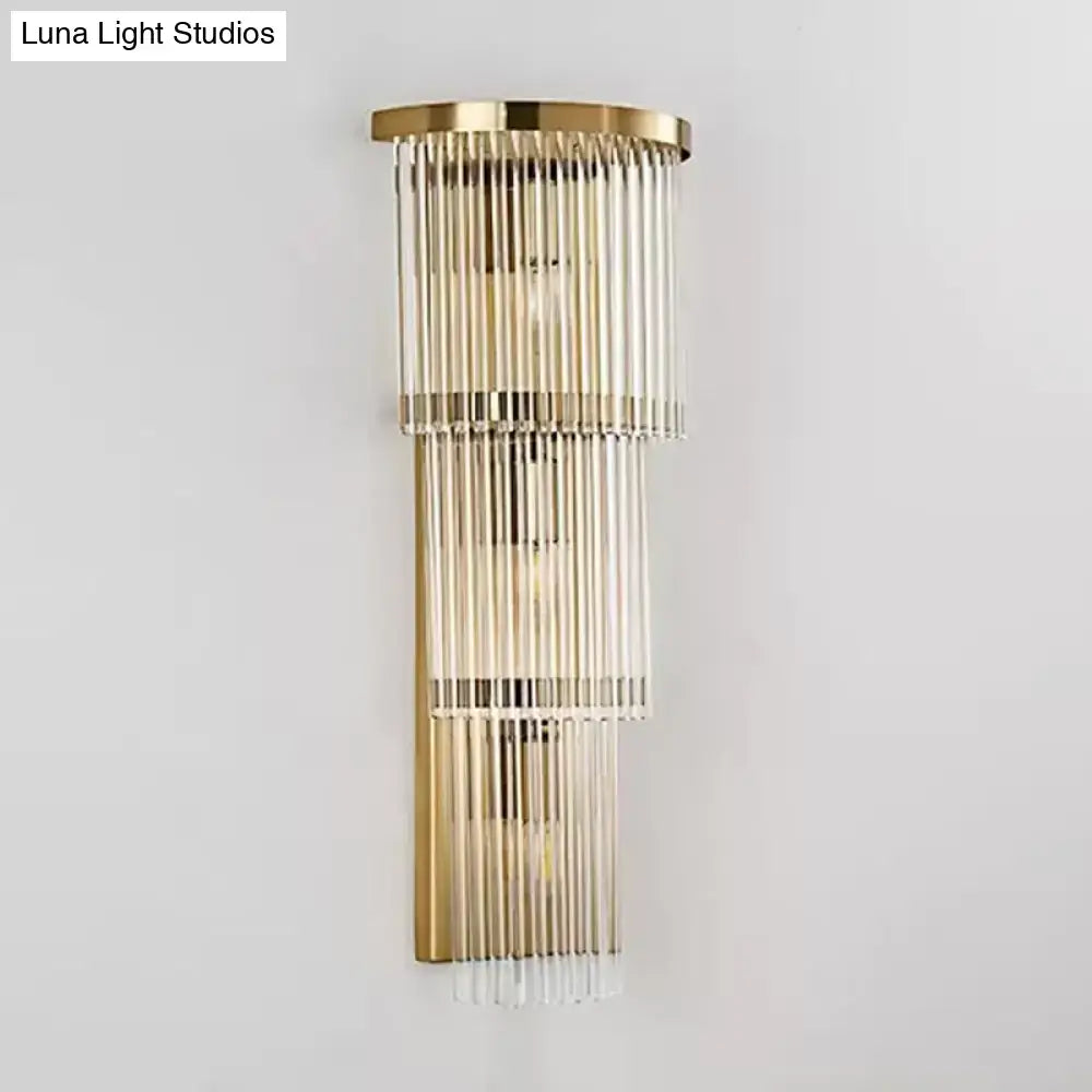 Postmodern gold-toned wall light with cascading clear glass rods as a chic wall light for living space and bedroom