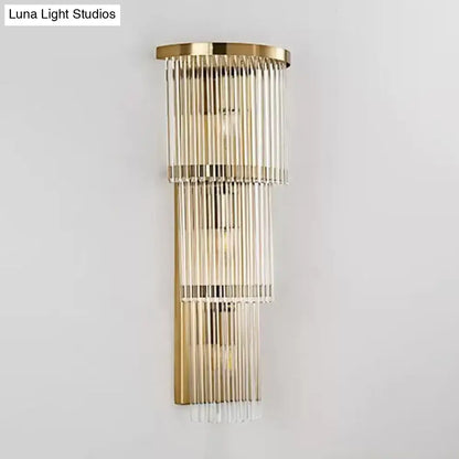 Postmodern gold-toned wall light with cascading clear glass rods as a chic wall light for living space and bedroom