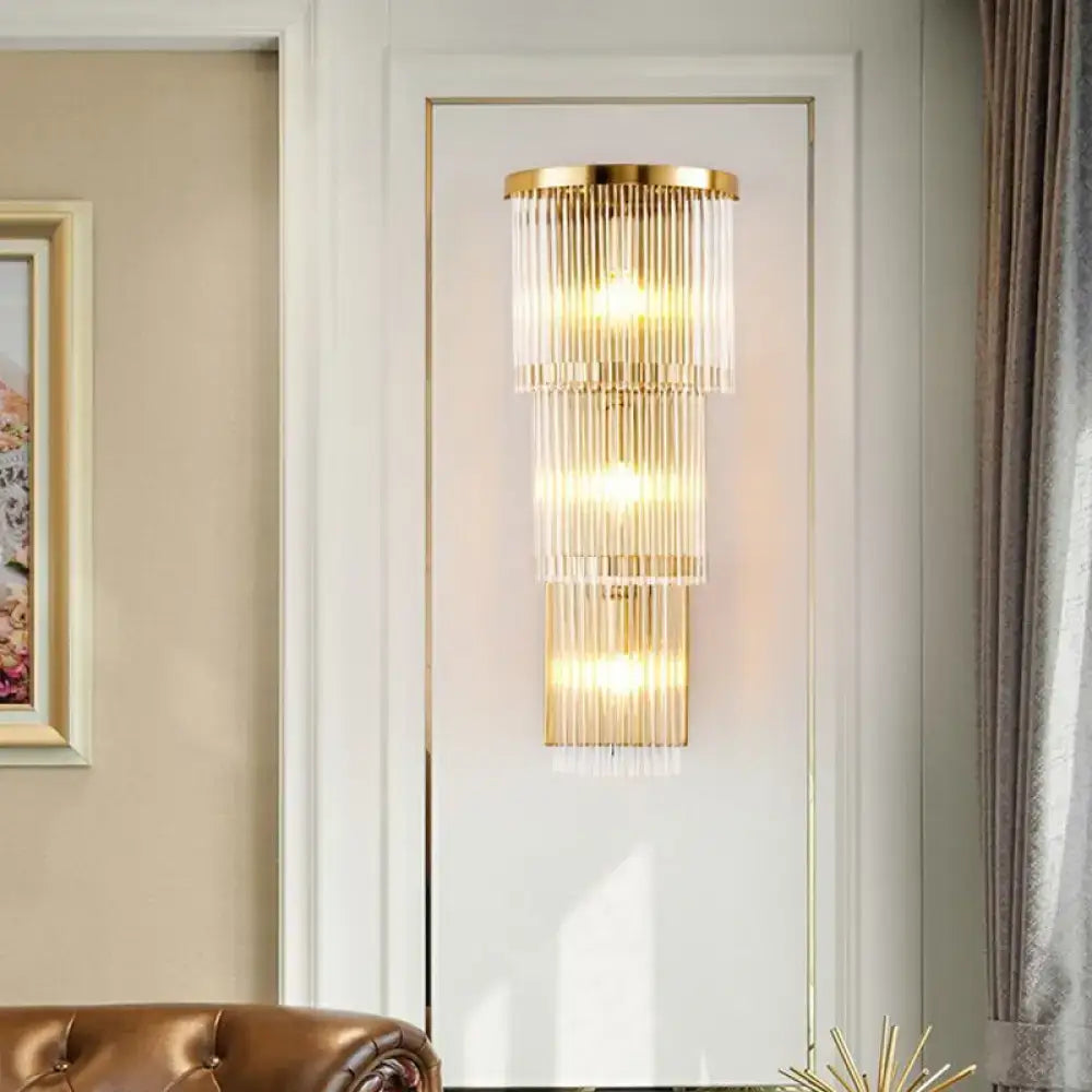 Postmodern gold-toned wall light with cascading clear glass rods for chic living space or bedroom lighting