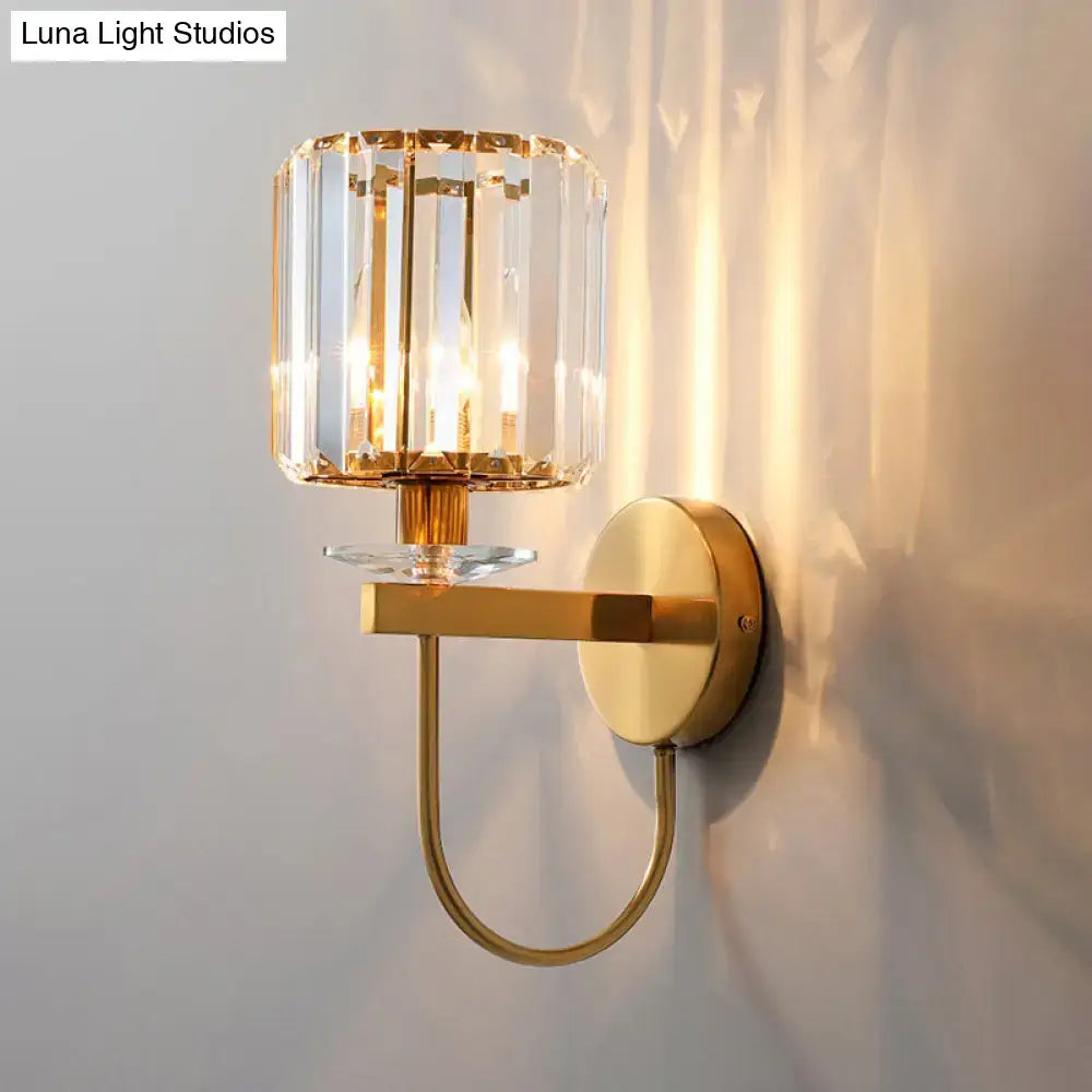 Gold-toned postmodern wall sconce with faceted crystal shade and curved arm from DecorBites™ collection