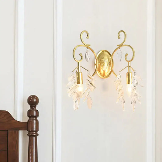 Postmodern gold curve arm sconce light with ornate curved arms and crystal teardrop accents for living room