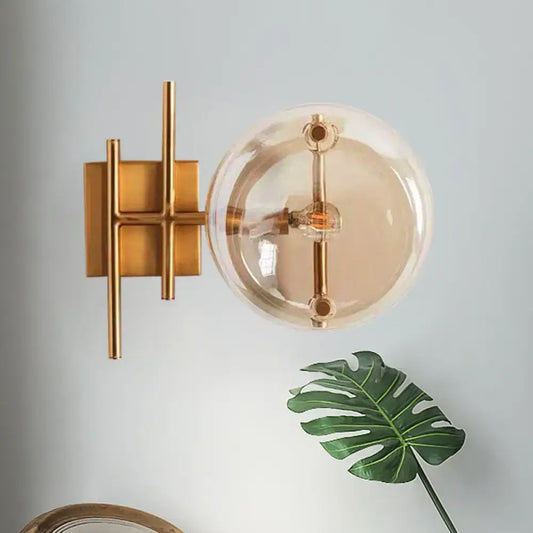 Postmodern gold double ball wall mounted light featuring a gold-toned metal bracket and smoked glass globe wall lamp