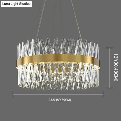 A modern circular pendant light with gold finish metal ring and k9 crystal prisms ideal for bedroom fixture width