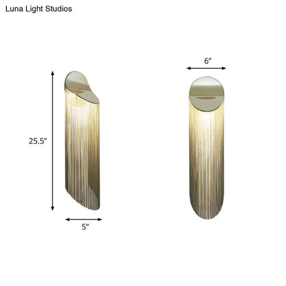Postmodern gold fringed wall light fixture with brushed gold finish and cascading vertical strands for bedroom sconce