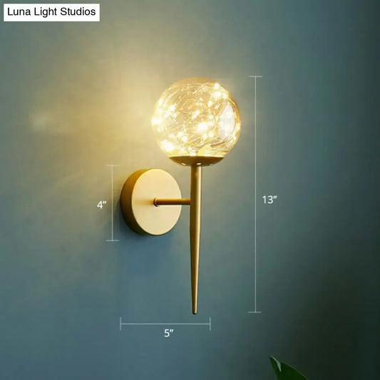 Postmodern gold glass globe wall light fixture with warm led fairy lights as a stylish bedroom wall light fixture