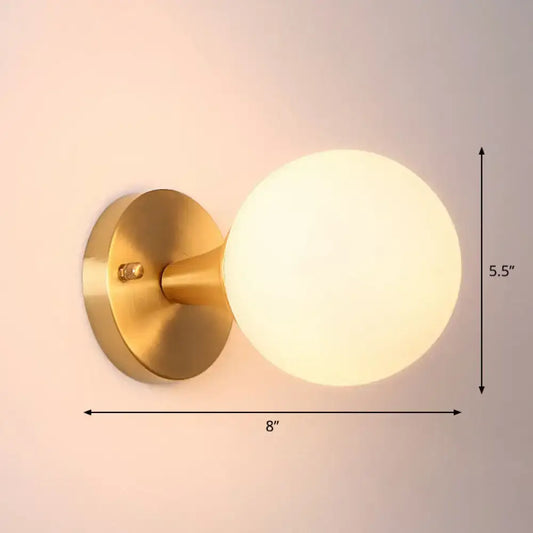 Postmodern gold-toned wall lamp with frosted milk glass globe sconce light for living room lighting