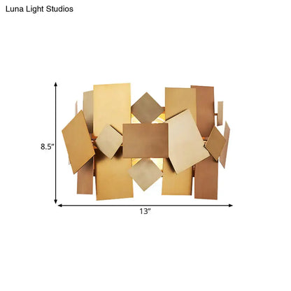 Postmodern gold stacked panel sconce light fixture with overlapping bronze and gold metallic rectangular panels for living room