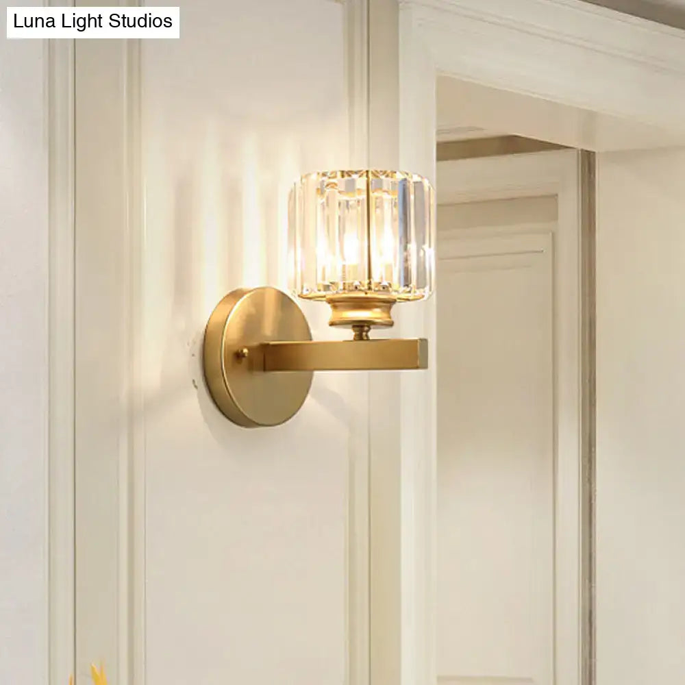 Postmodern gold wall lamp featuring a gold-toned base with a prismatic crystal glass shade for bedroom use