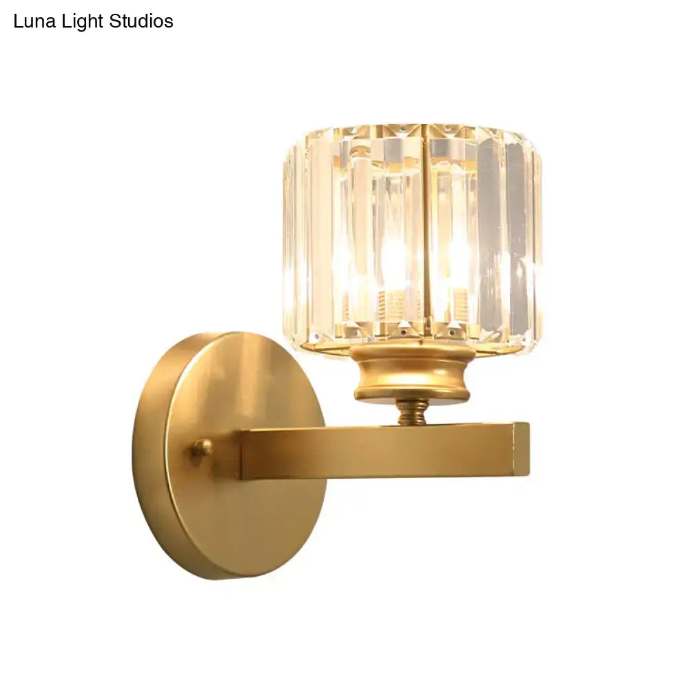 Gold-finished wall lamp with prismatic crystal shade featuring a faceted design for bedroom sconce lighting