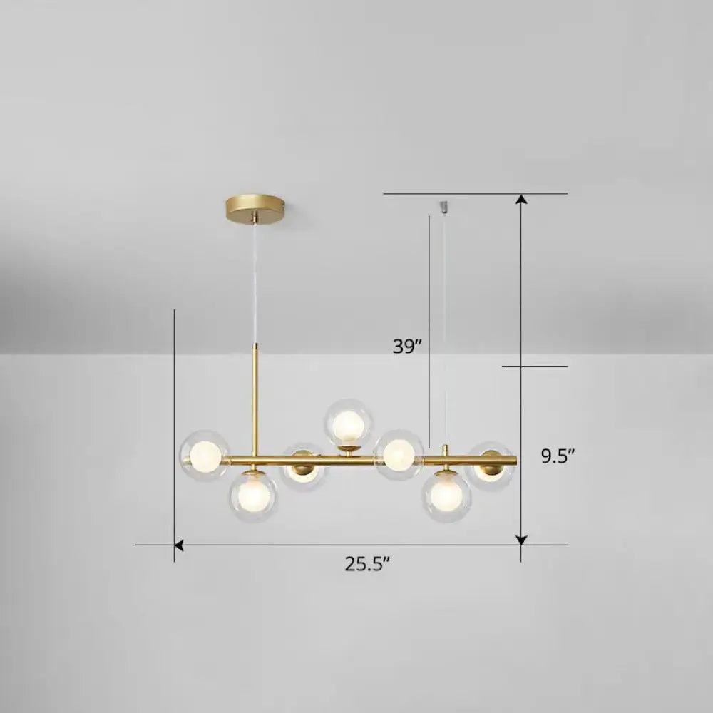 Modern brass pendant chandelier with six clear glass globe bulbs in clear smoke grey for dining room lighting
