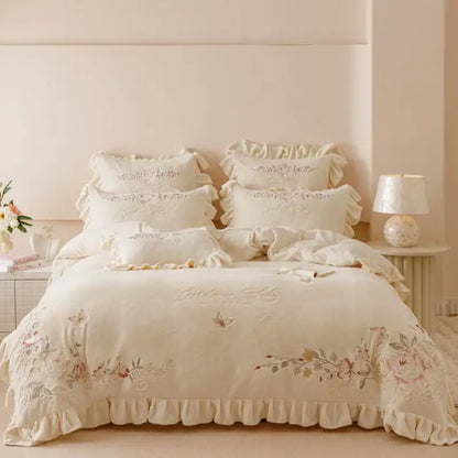 Cream-colored bedding set with delicate flowers embroidery ruffles lace detailing and ruffled edges for bedroom decor