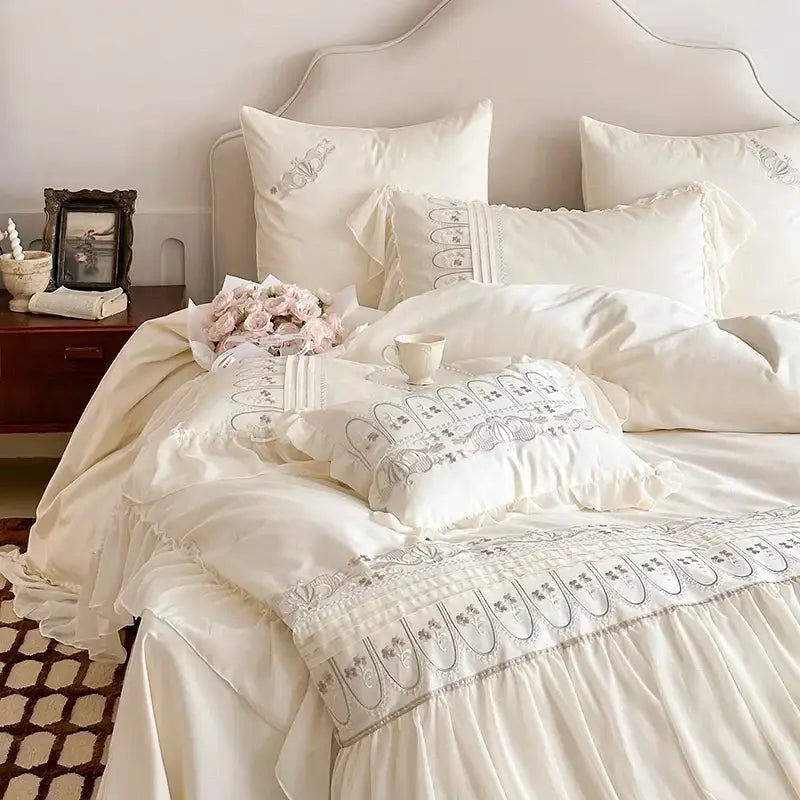 Cream-colored princess wedding bedding set with ruffled fabric and delicate gray decorbites flowers embroidery