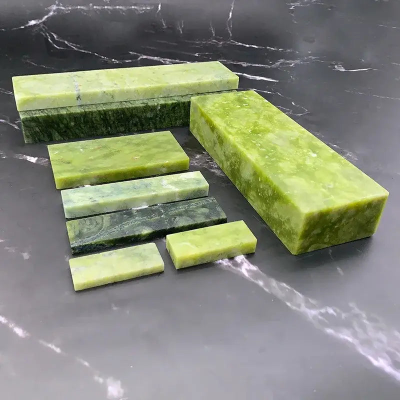 Professional green stone knife sharpener set with polished jade blocks featuring natural marbled patterns for kitchen use