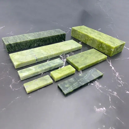 Set of seven green jade stone sharpener set with natural marbled patterns for professional kitchen honing block use