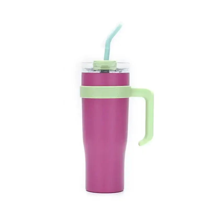 A magenta stainless steel sippy cup travel mug with a light green handle and straw lid for kitchen use