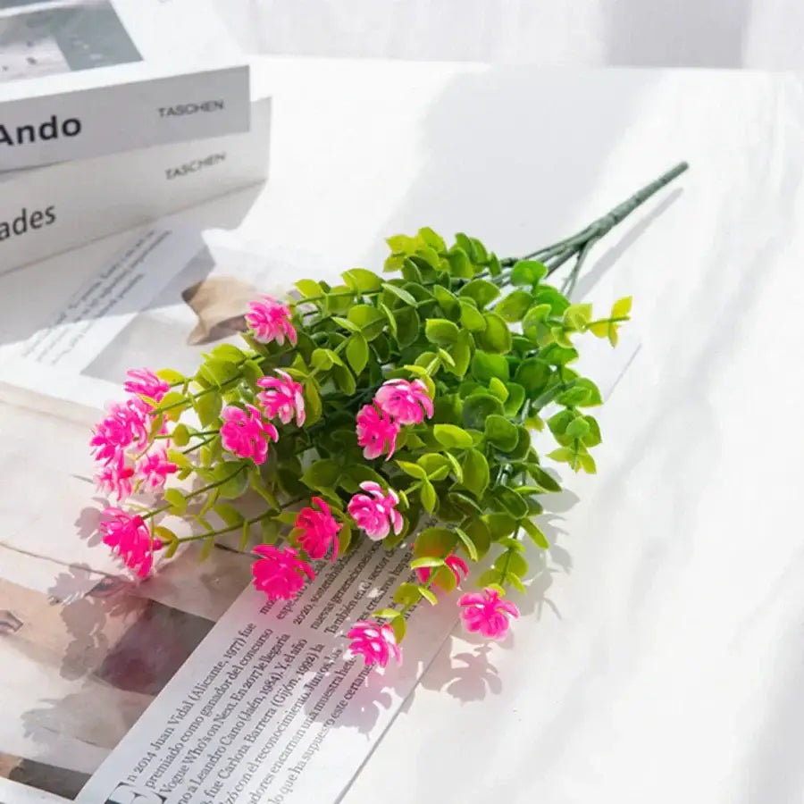 A vibrant pink decorbites artificial eucalyptus plant with lush green foliage made from synthetic materials for decorbites artificial use