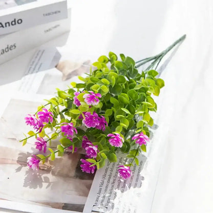 A decorbites artificial eucalyptus plant featuring a cluster of pink and white flowers with green leaves for decor