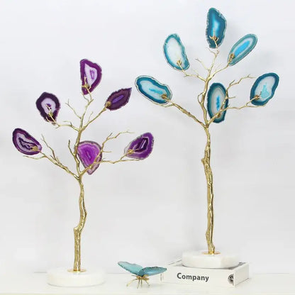 Two decorative purple and teal agate tree metal sculptures with gold branches on white marble bases for living room decor