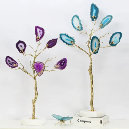 Two decorative purple and teal agate tree metal sculptures with gold branches on white marble bases for living room decor