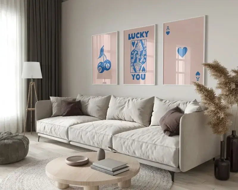Beige upholstered sectional sofa with dark brown throw pillows beside decorbites™ 3-piece retro queen of hearts wall art set