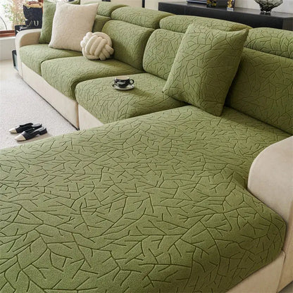 Olive green textured quilted sofa cover with elastic fit and leaf pattern for living room use