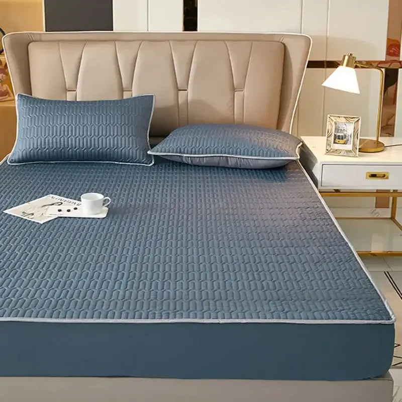 Blue quilted latex fitted sheet set with subtle geometric pattern and white piping for cooling mattress pad