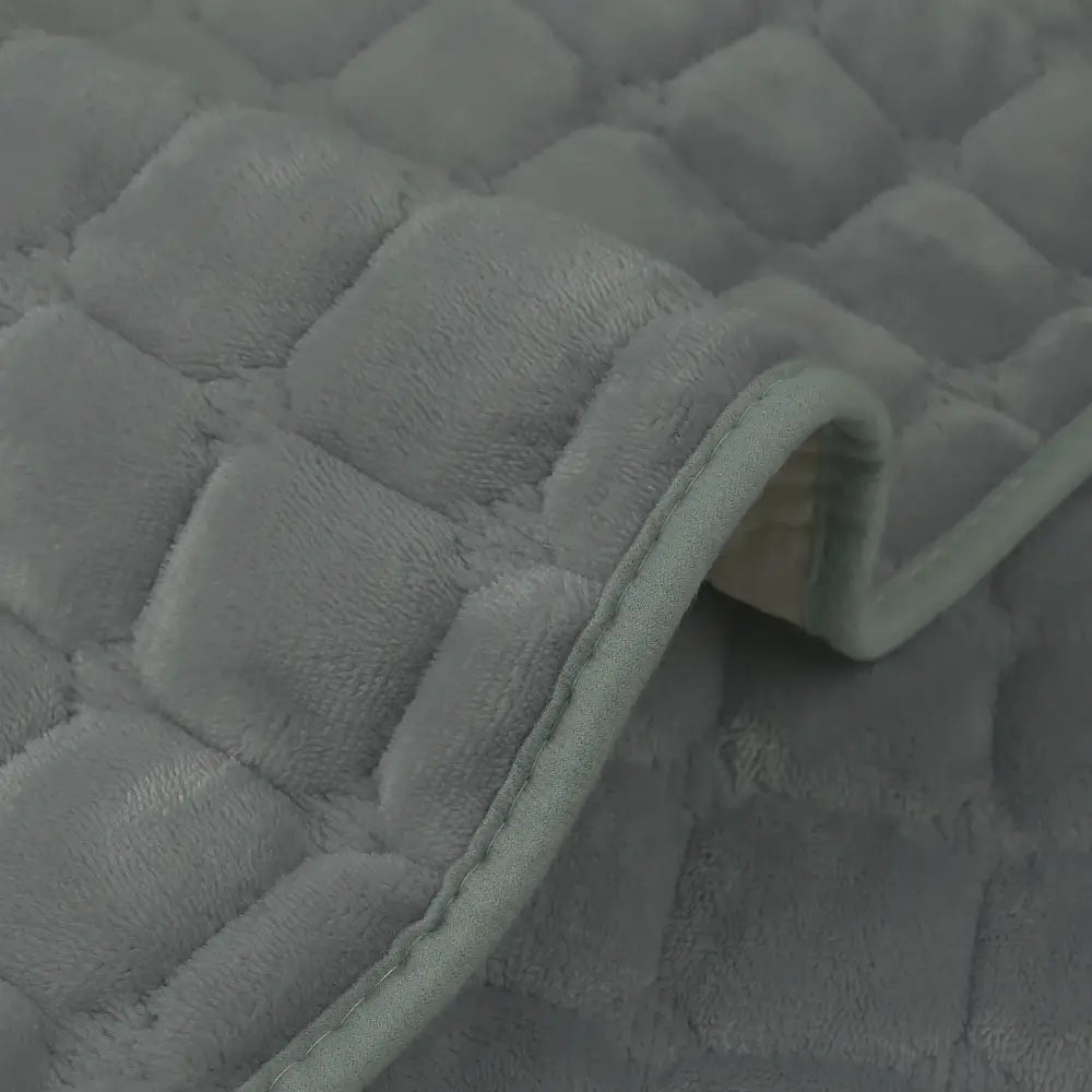 Soft gray quilted plush sofa cover with fuzzy texture and subtle edge stitching non slip for living room use