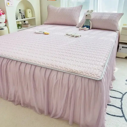 Pink quilted bed skirt set with ruffled skirt and silver trim for bedroom bed pad décor and protection
