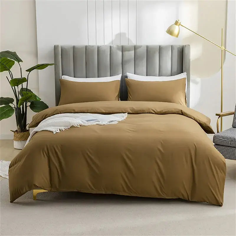 Quilted tan duvet cover set with warm caramel color and soft smooth fabric finish including matching pillowcases
