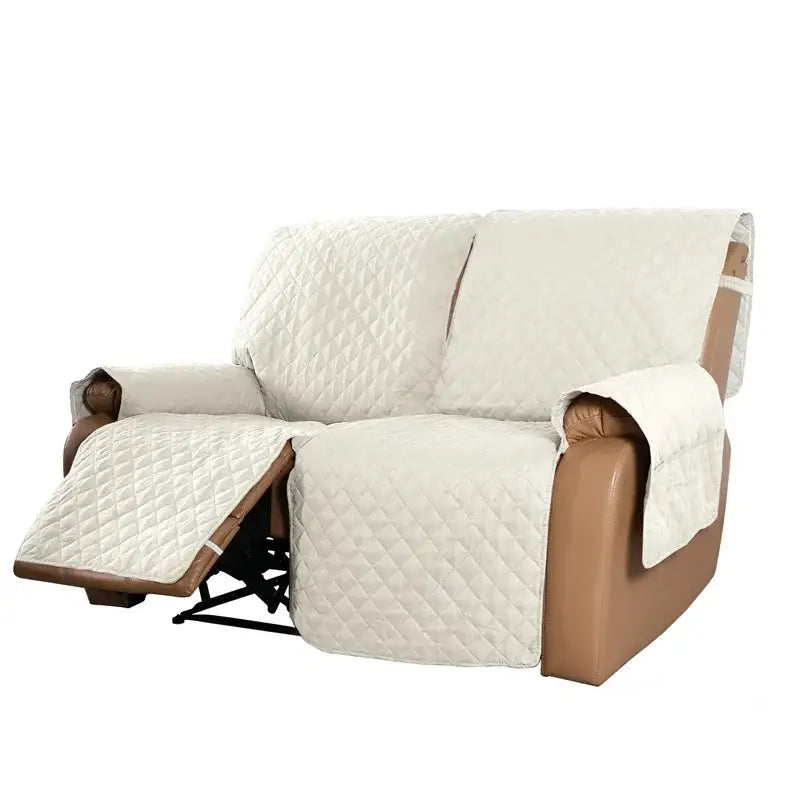 Cream-colored quilted fabric recliner slipcover with diamond-stitched pattern designed for living room use