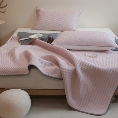 Pink quilted bedspread with gray border part of decorbites ice bean cooling mat pillowcase set for bedroom use