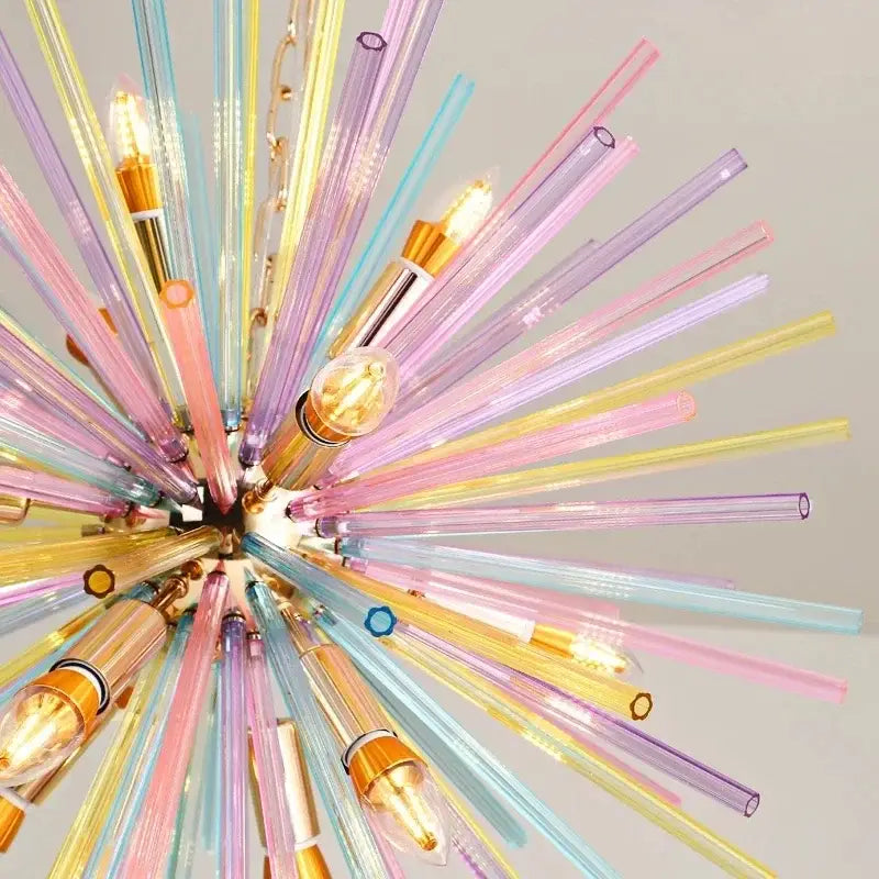 Pastel-colored glass pendant light with translucent pink yellow blue and purple rods radiating from brass decorbites dandelion chandelier
