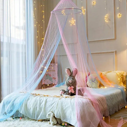 Pastel pink and light blue sheer mesh hanging mosquito nets with a circular metal frame and star lights canopy