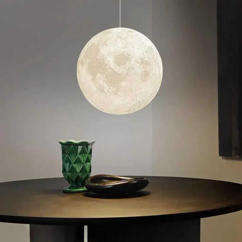 A realistic white and yellow moon high polymer pendant light with textured surface ideal for bedroom use