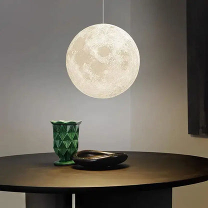 A realistic white and yellow moon high polymer pendant light with textured surface ideal for bedroom use