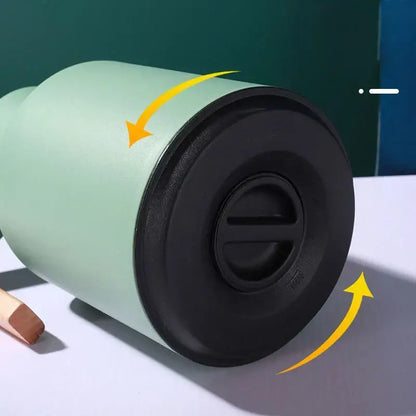 Mint green insulated water thermos kettle with black screw-on lid and flip-top opening for convenient use