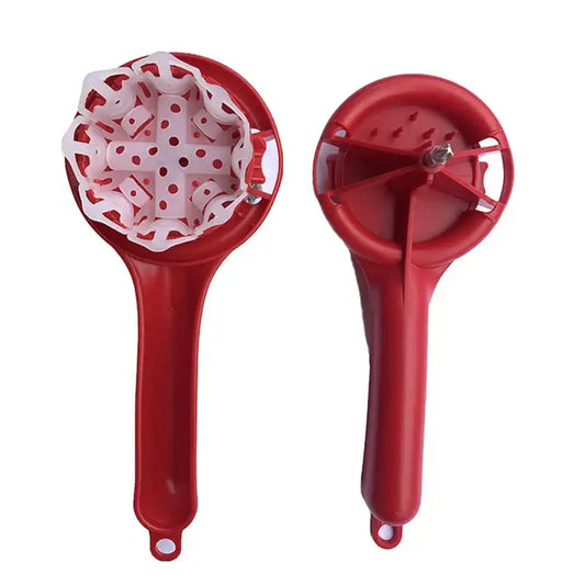 Red plastic potato masher with white perforated insert used as an espresso machine cleaning brush for kitchen use