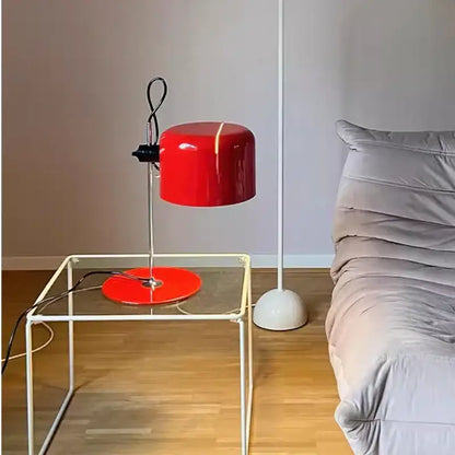 Vibrant red and black chrome coupe table lamp with glossy finish on chrome stand resting on glass table decorbites chrome coupe