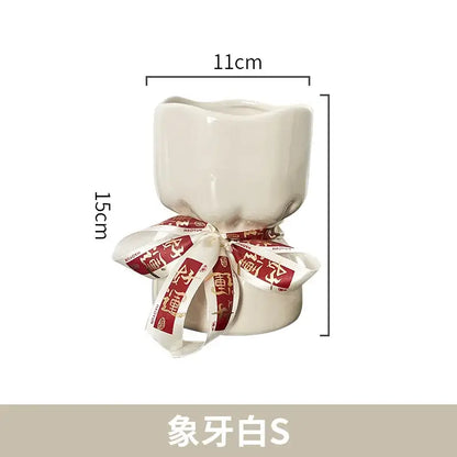 Cream-colored bouquet shape ceramic planter with red and white ribbon decorbites bouquet shape floral decor
