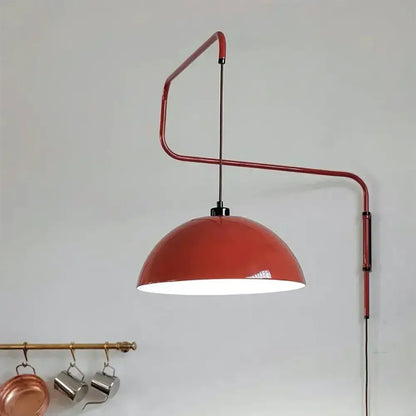 Red enamel dome adjustable pendant light with curved metal arm designed for kitchen island lighting