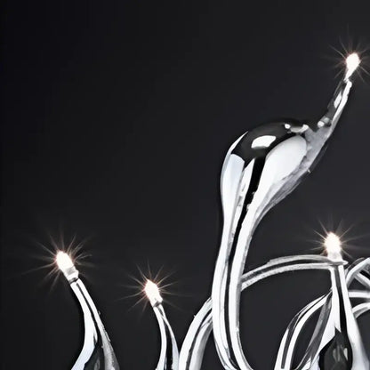 Silver metallic chandelier with flowing sculptural arms and glowing bulbs as a swan pendant lamp for living rooms