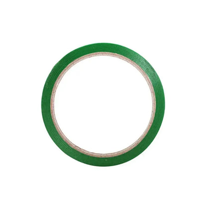 A roll of vibrant green matte bag seal tape wound neatly on a light brown cardboard core for kitchen freshness sealing