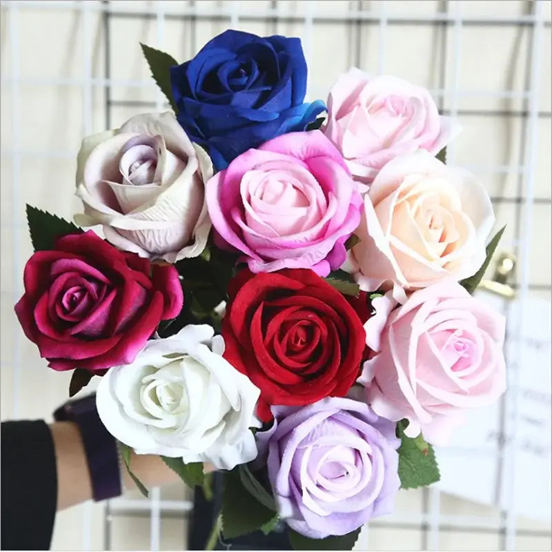 A vibrant bouquet of dried roses artificial in red pink cream blue and lavender for wedding decor by decorbites dried roses
