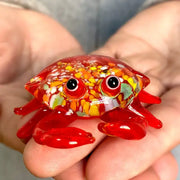 A vibrant red decorbites crab glass figurine with colorful speckles and detailed glossy eyes for living room art decor