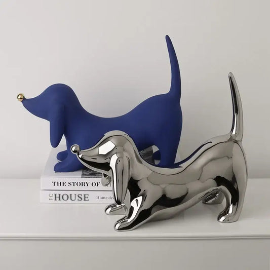 A sleek reflective silver dachshund art statue with polished metallic finish for home decor and decorbites doberman collection