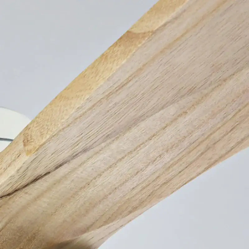 Light-colored wooden beam detail of a retro ceiling fan with dark wood blades and 15w ceiling lights for bedroom use