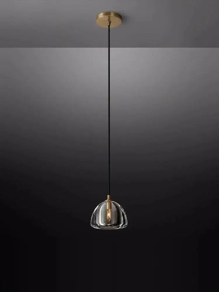 A sleek decorbites black brass retro pendant light with clear crystal glass dome for modern dining room decor