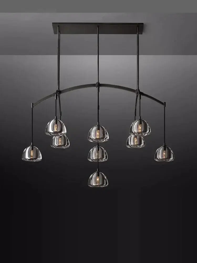 Modern black brass retro chandelier with seven clear glass globe shades for elegant dining room decorbites black brass lighting